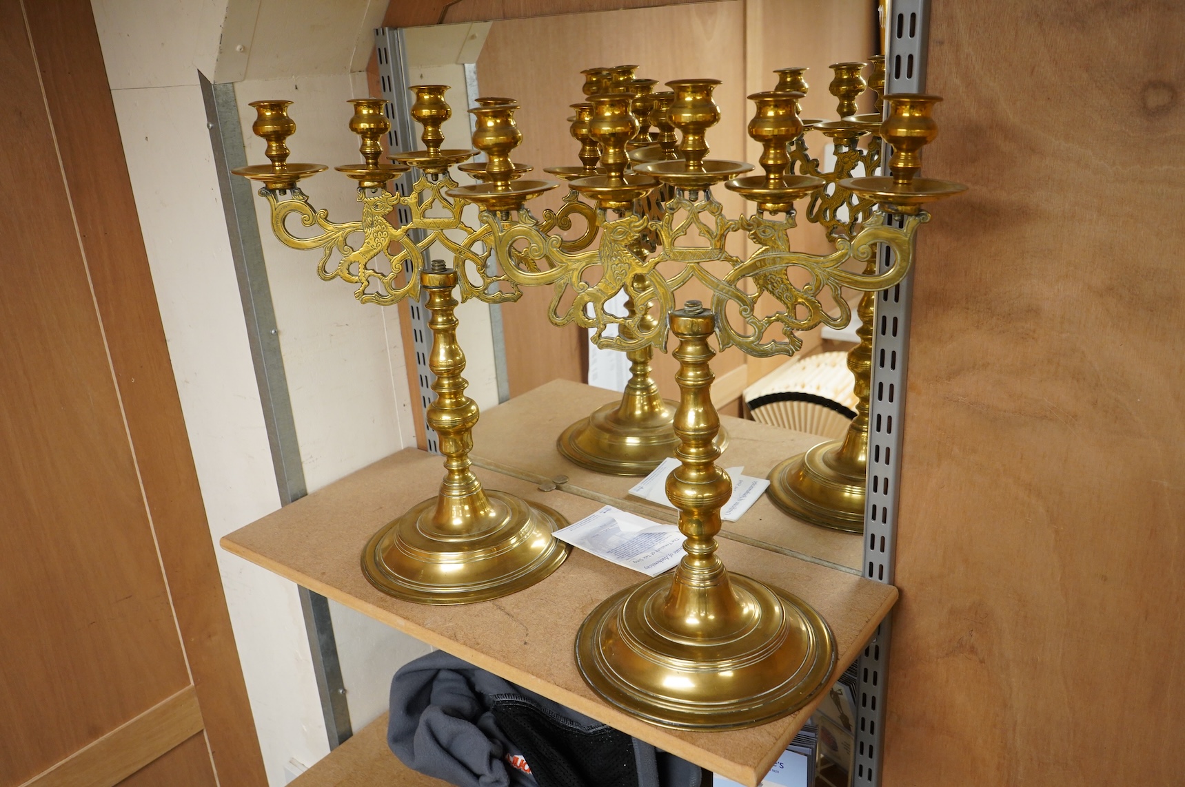 A pair of Juddah Sabbath five light brass candlesticks, 50cm high